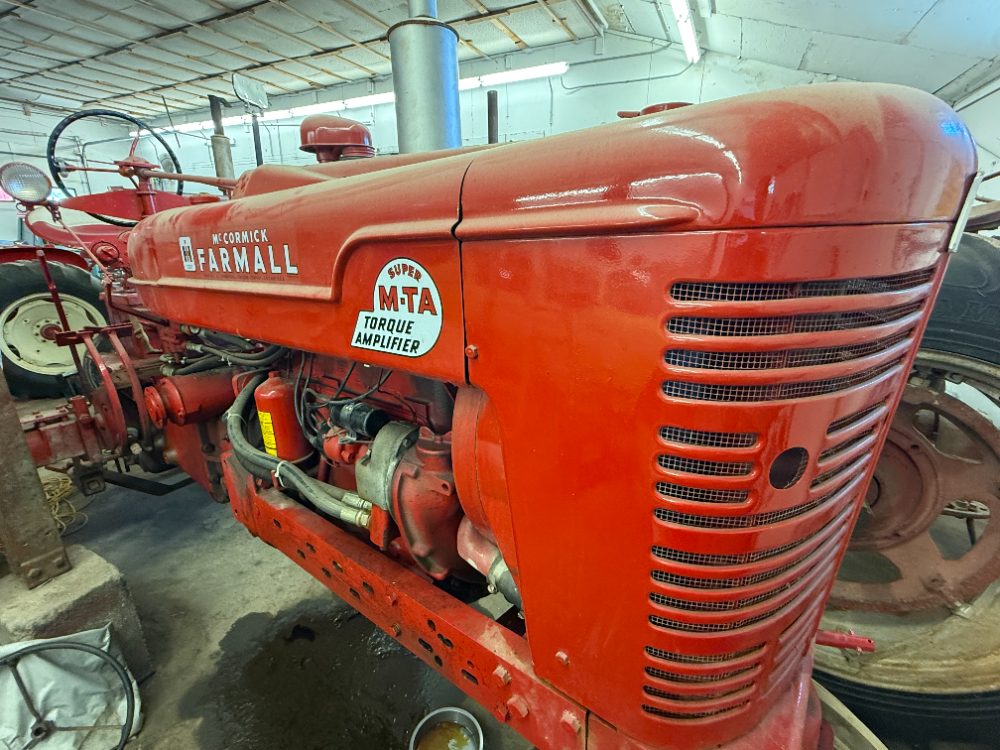 Red McCormick Farmall Super M-TA tractor with Torque Amplifier badge